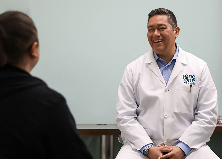 One to One Health provider smiling during patient visit
