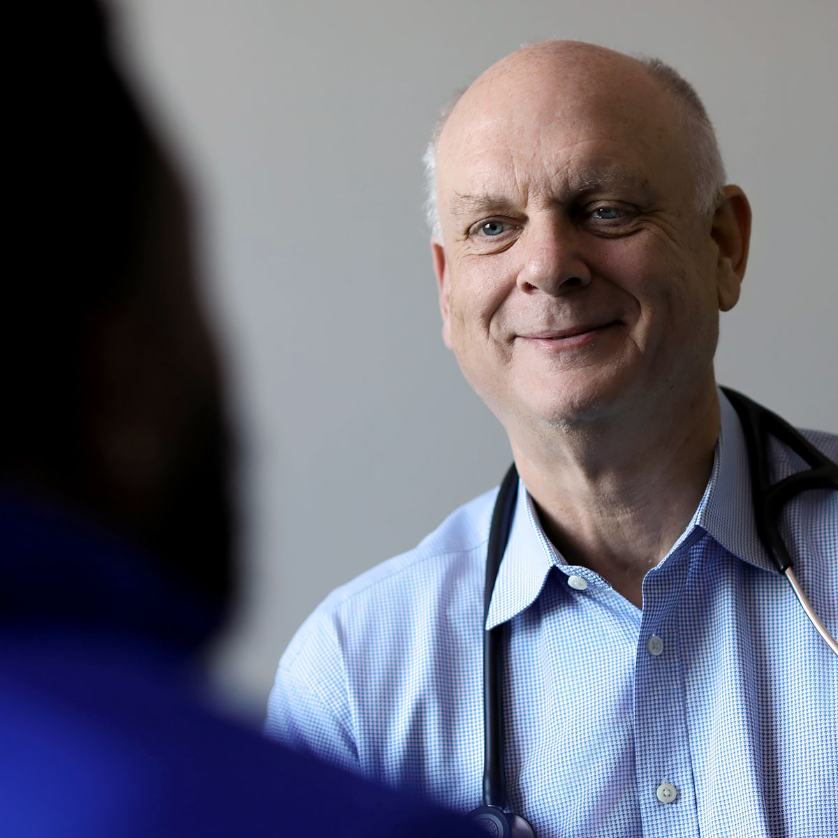 Dr. Keith Helton, founder of One to One Health, smiling with a patient