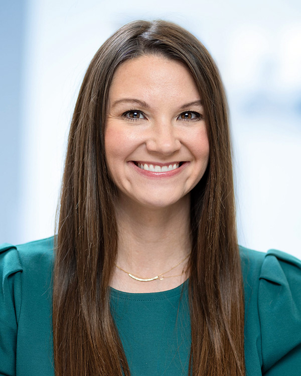 Portrait of Jocelyn Chambers, Vice President of Client Development at One to One Health, smiling in a teal top with a light background