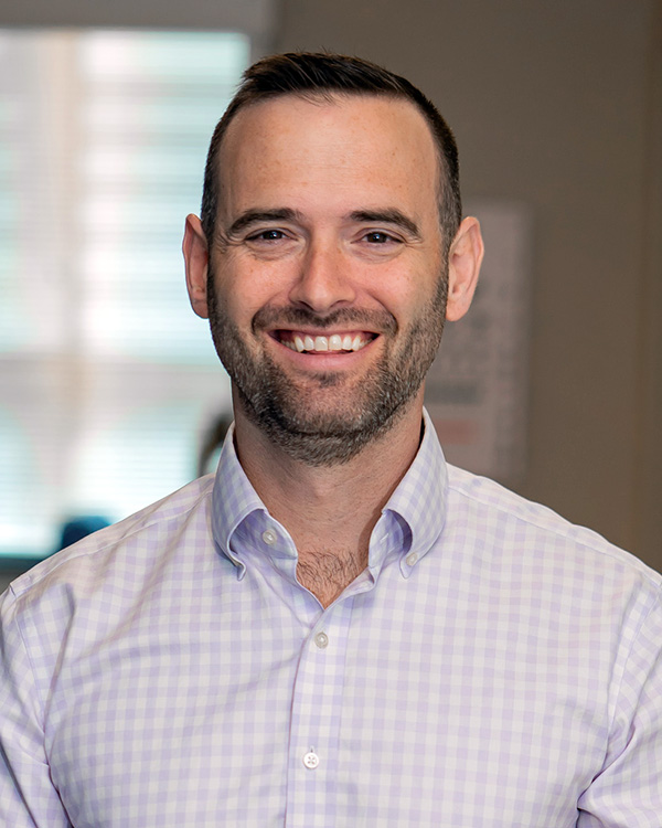 Portrait of Dave Kinzler, CEO of One to One Health, smiling in a clinical setting